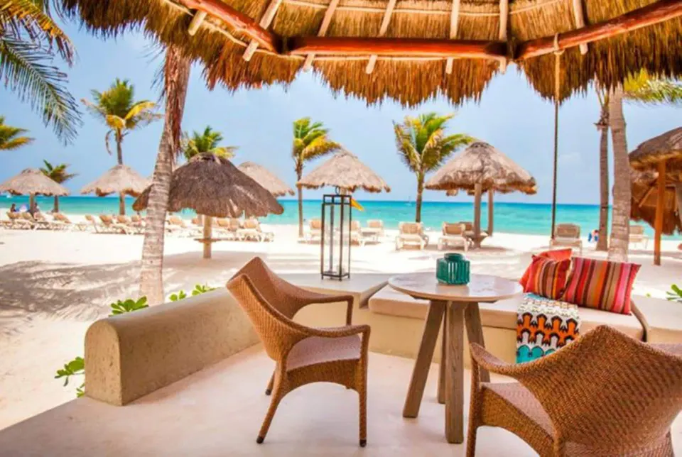 Ocean View room terrace with lounge seating by the beach at Mahekal Beach Front Resort & Spa.