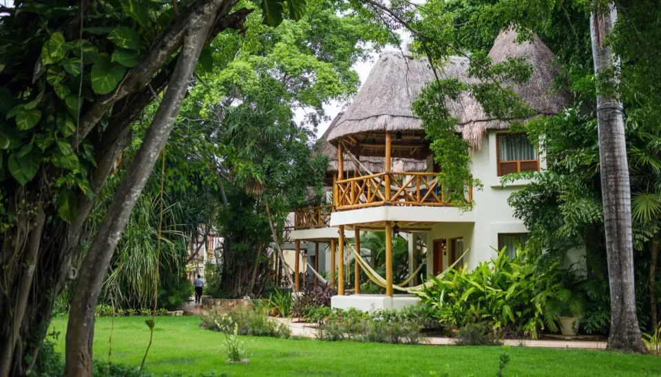 Run of House guest room building with balconies in gardens at Mahekal Beach Front Resort & Spa.