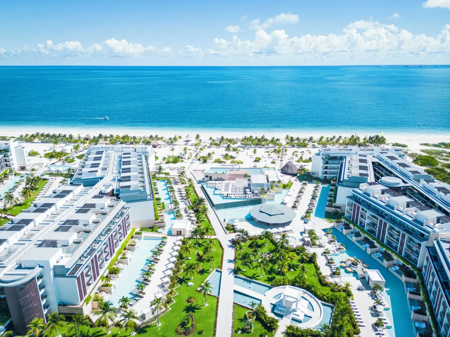 Aerial view of pools, gardens, beach, and ocean at Majestic Elegance Costa Mujeres.