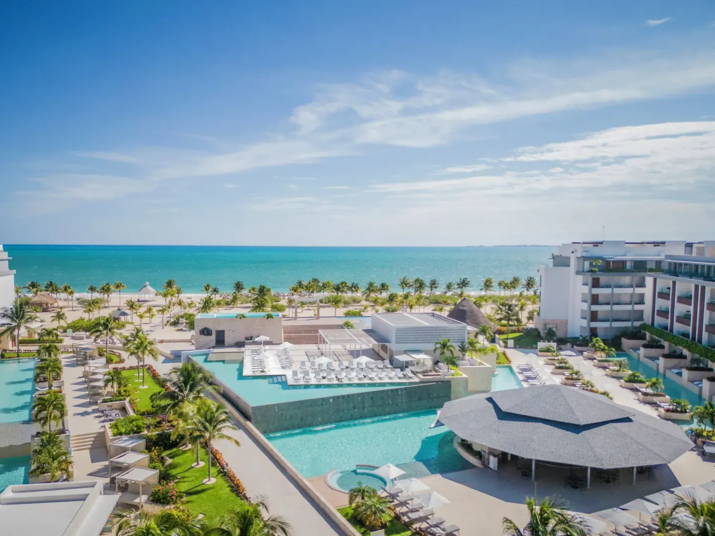 Elevated view of resort pools and oceanfront at Majestic Elegance Costa Mujeres.