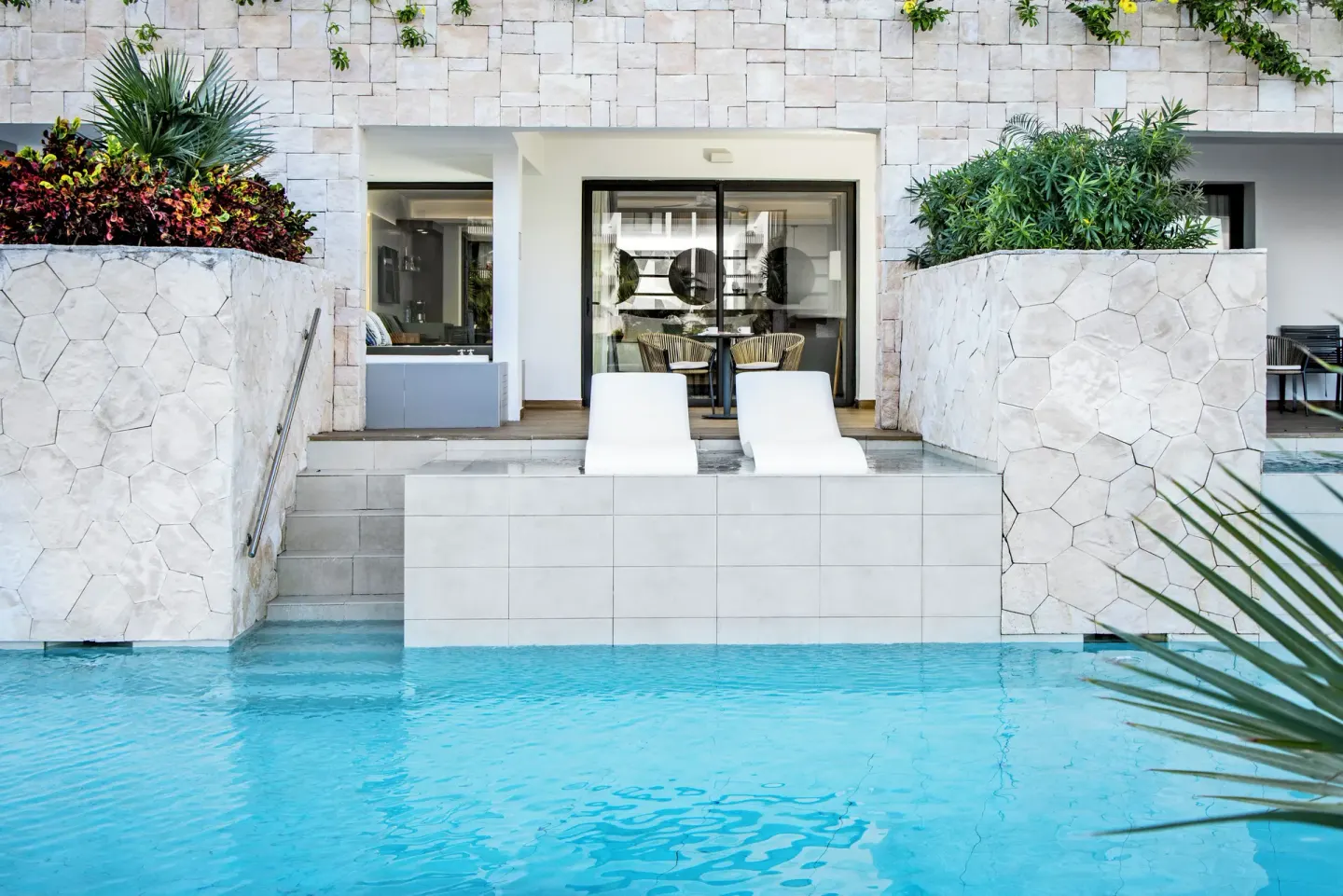 Swim-up terrace with two loungers at Majestic Elegance Costa Mujeres.