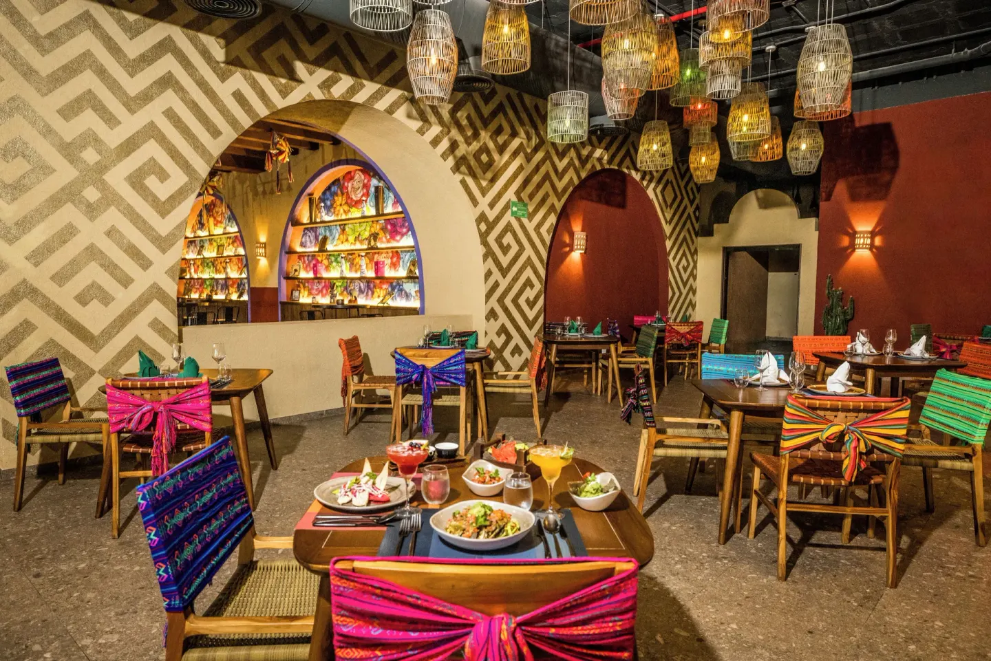 Colorful Mexican-style restaurant dining room at Majestic Elegance Costa Mujeres.