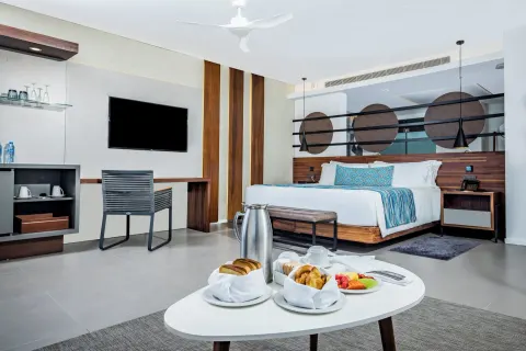 Elegance Club Plunge Pool Suite bedroom with king bed at Majestic Elegance Costa Mujeres.