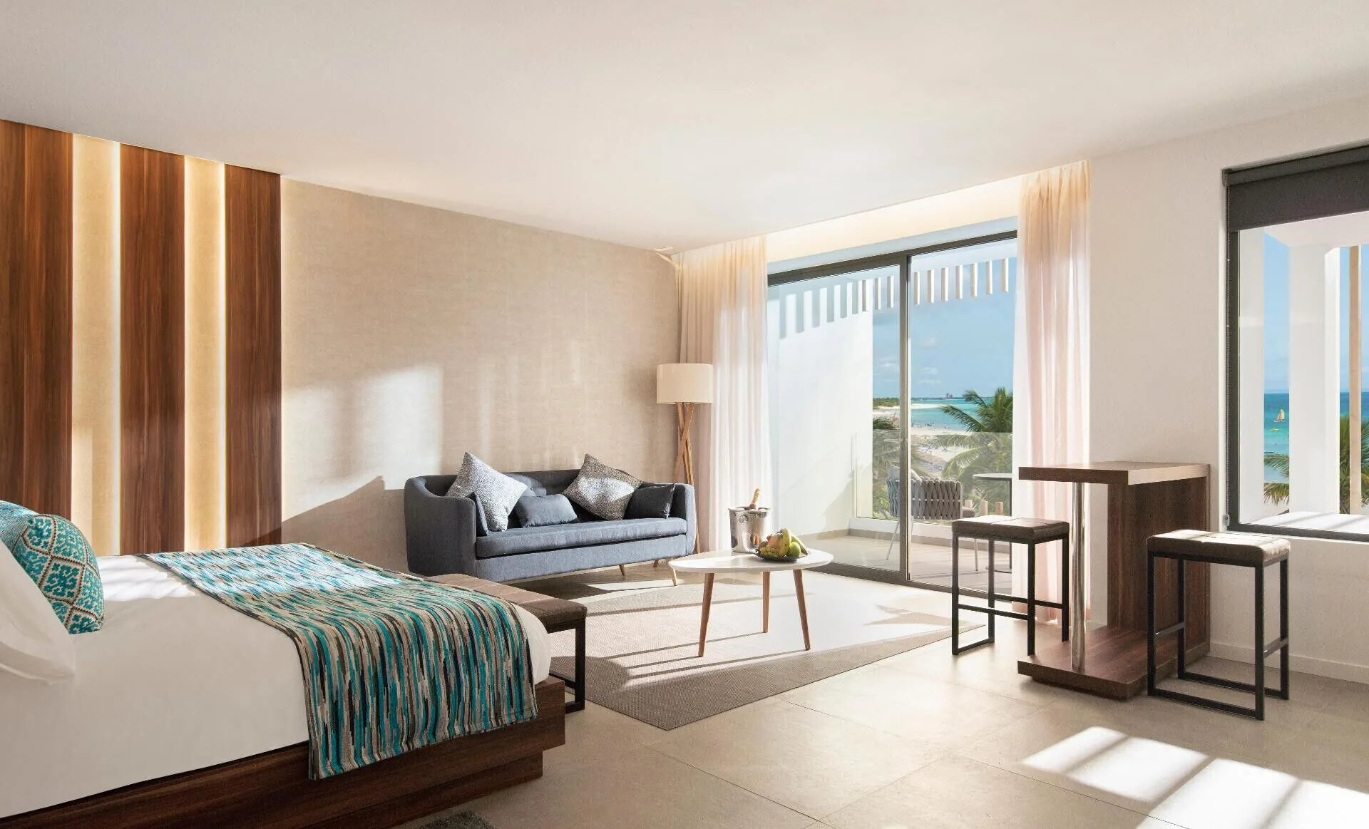 Junior Suite Outdoor Jacuzzi guest room with bed and ocean-facing balcony at Majestic Elegance Costa Mujeres.