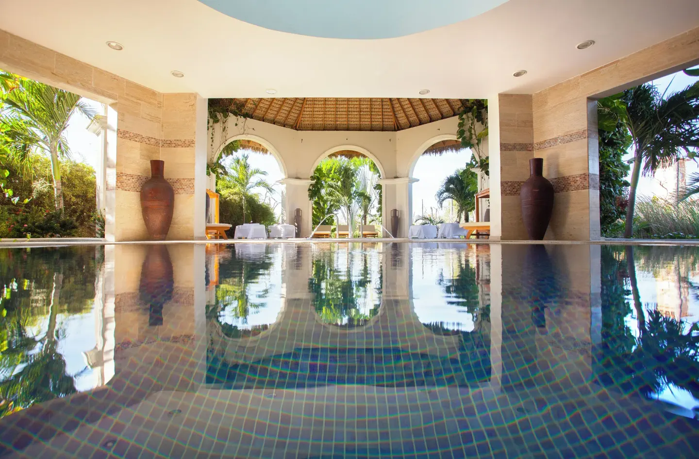 Covered spa pool with arched openings at Majestic Elegance Punta Cana.