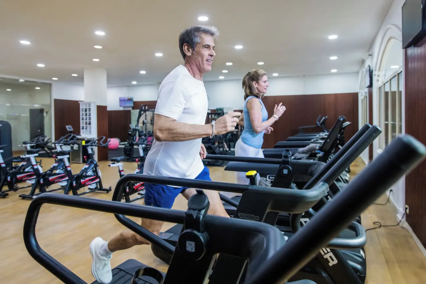 Guests run on treadmills in the fitness center at Majestic Elegance Punta Cana.