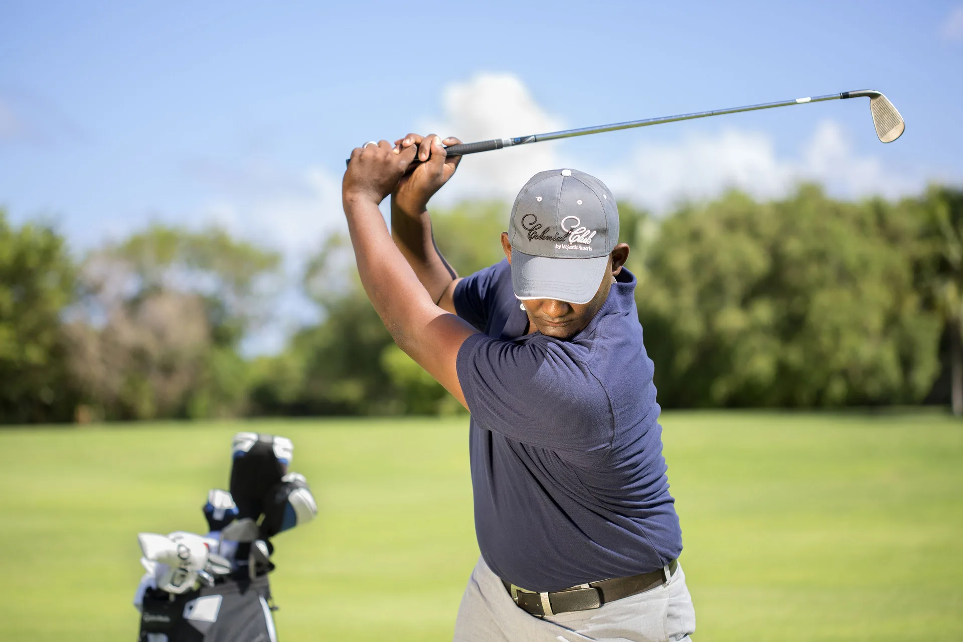 Golfer preparing a swing on the course near Majestic Elegance Punta Cana.