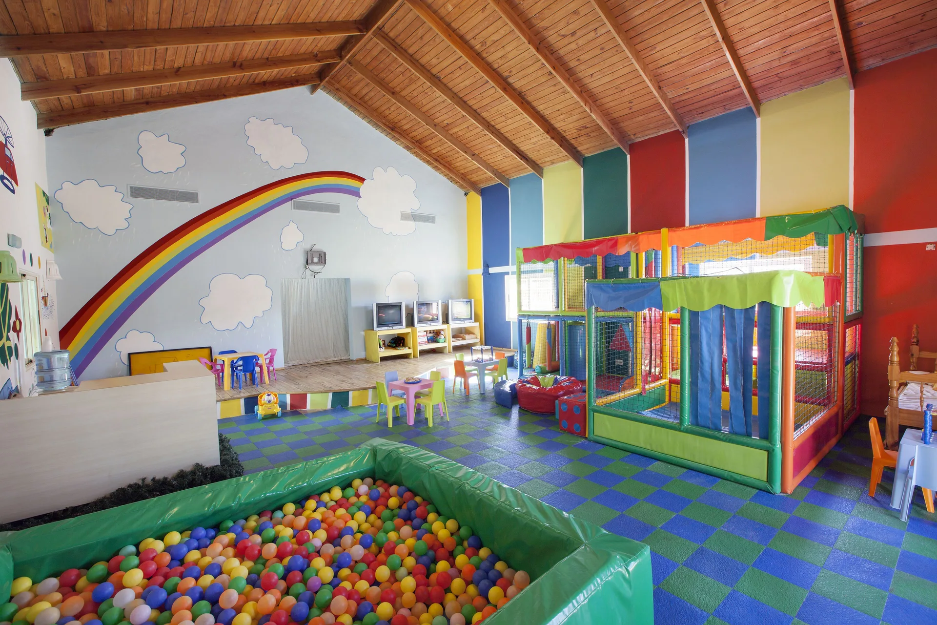 A colorful kids' club playroom with a ball pit at Majestic Elegance Punta Cana.
