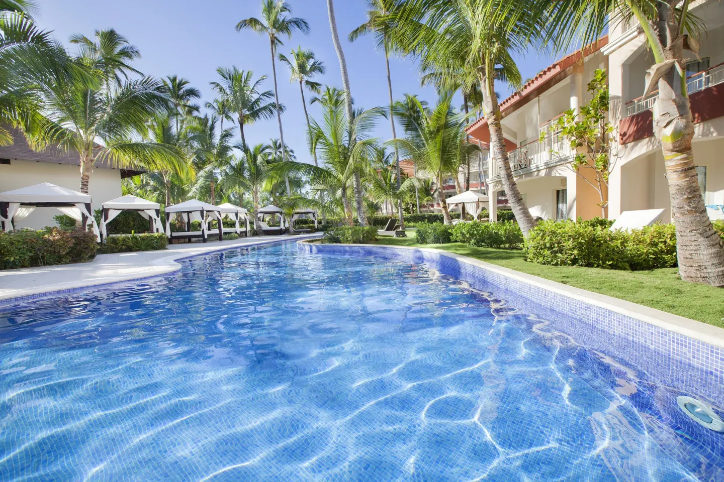 Quiet pool channel beside cabanas and guest buildings at Majestic Elegance Punta Cana.