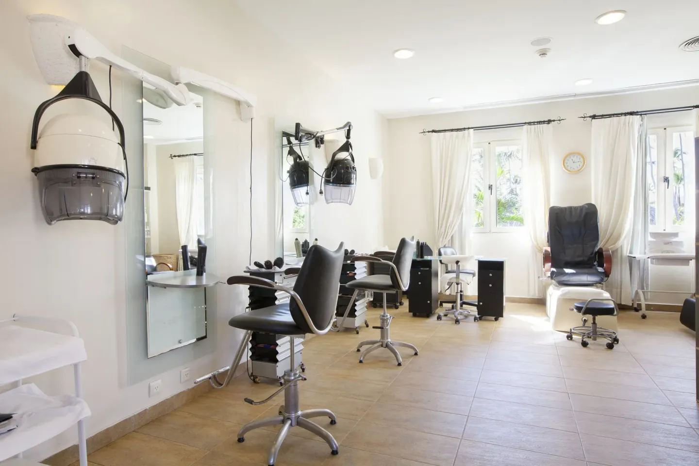 Salon stations with mirrors and styling chairs at Majestic Elegance Punta Cana.