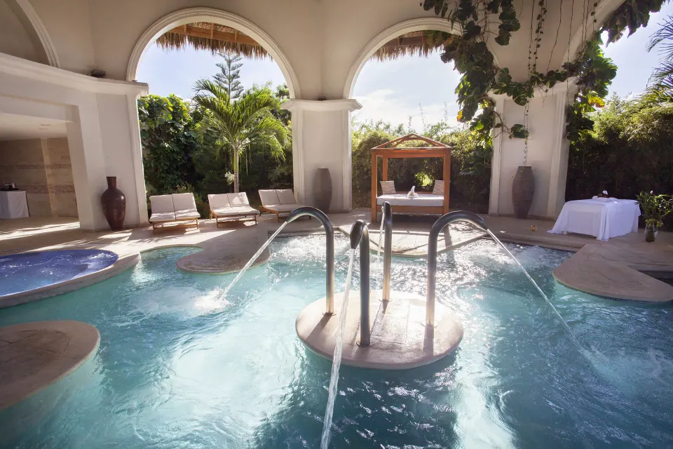 A spa hydrotherapy pool with water jets is shown at Majestic Elegance Punta Cana.