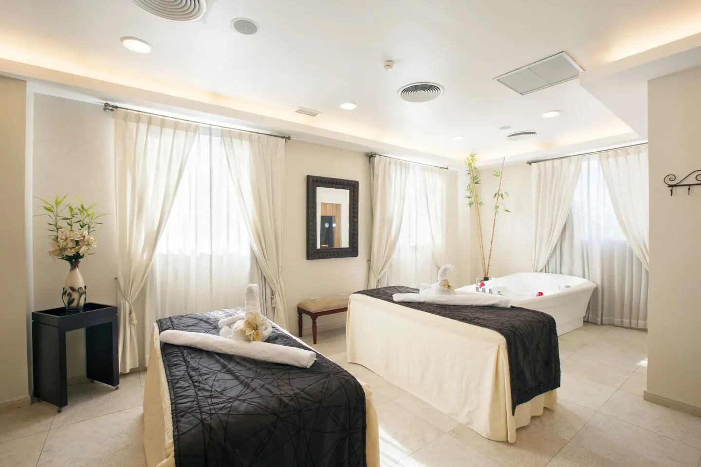 Spa suite with massage tables and soaking tub at Majestic Elegance Punta Cana.