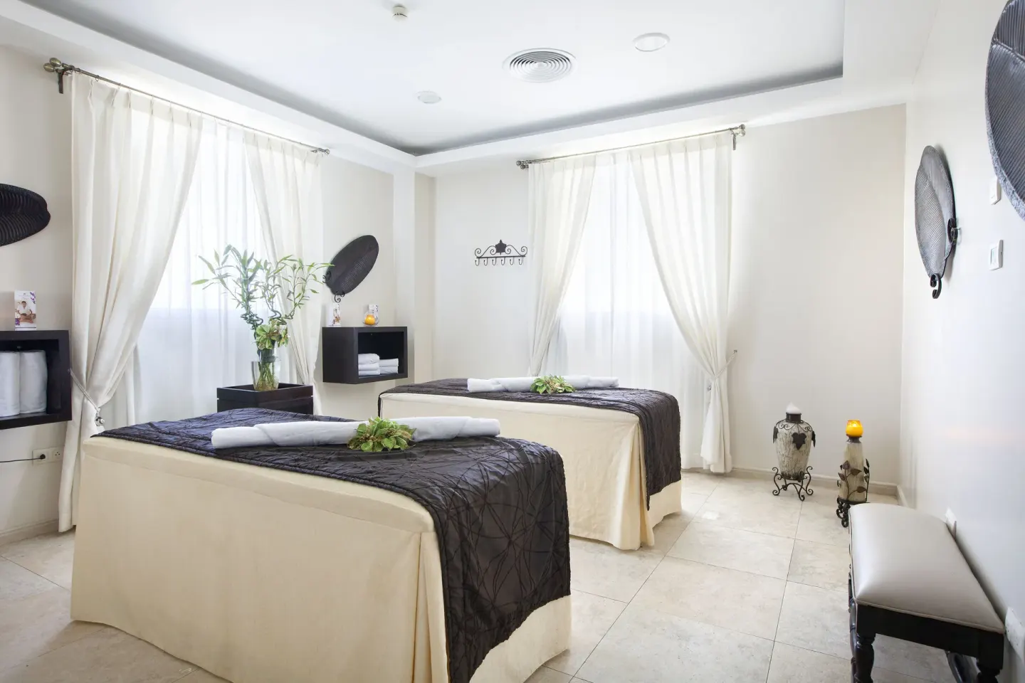 Spa treatment room with two massage tables at Majestic Elegance Punta Cana.