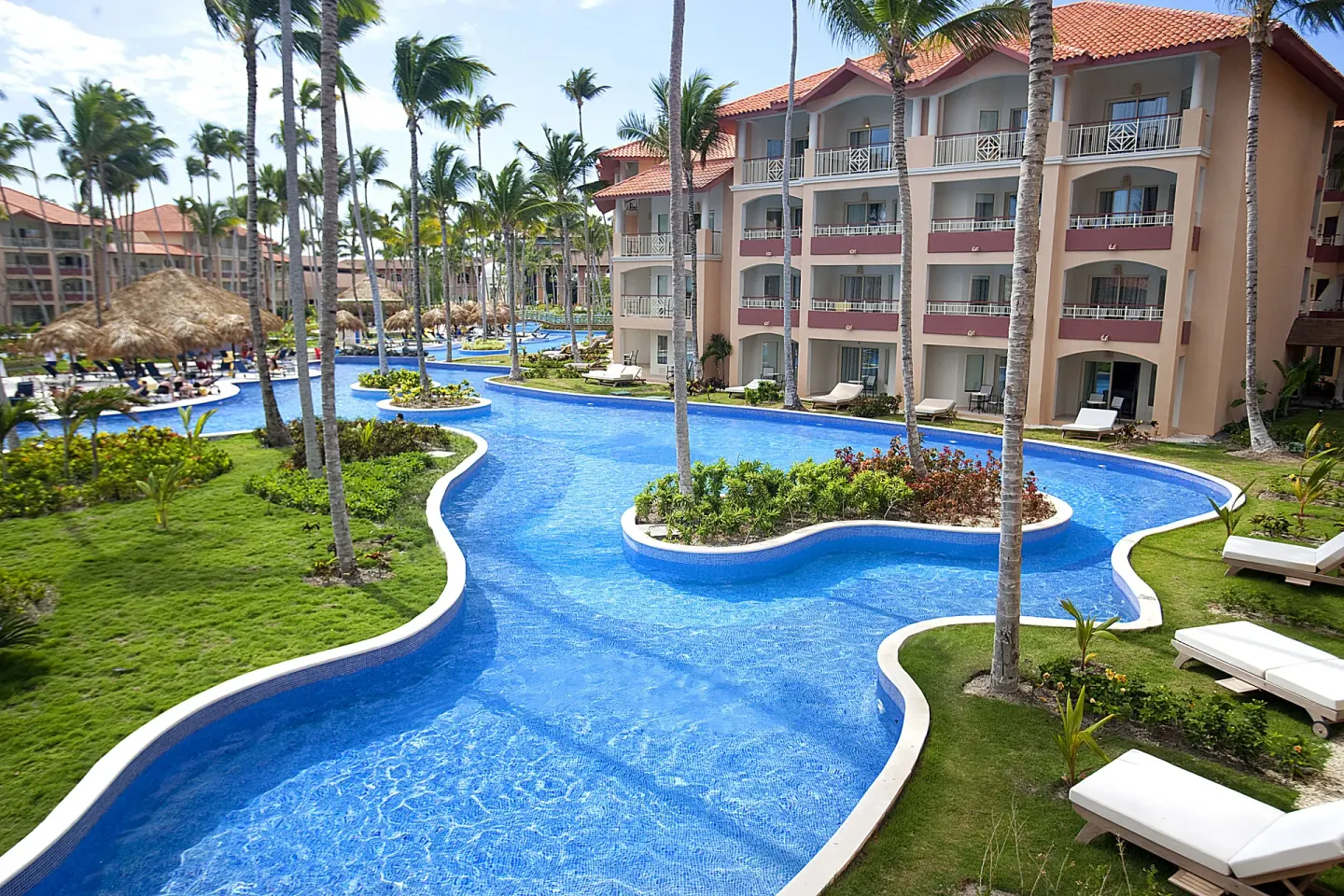 Winding pool between resort buildings at Majestic Elegance Punta Cana.