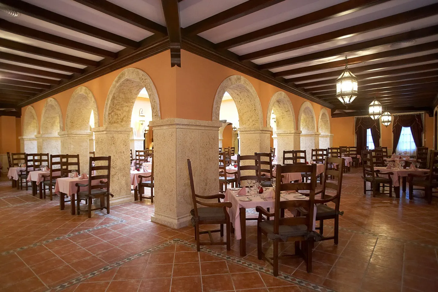 Rustic arched restaurant dining room at Majestic Elegance Punta Cana.