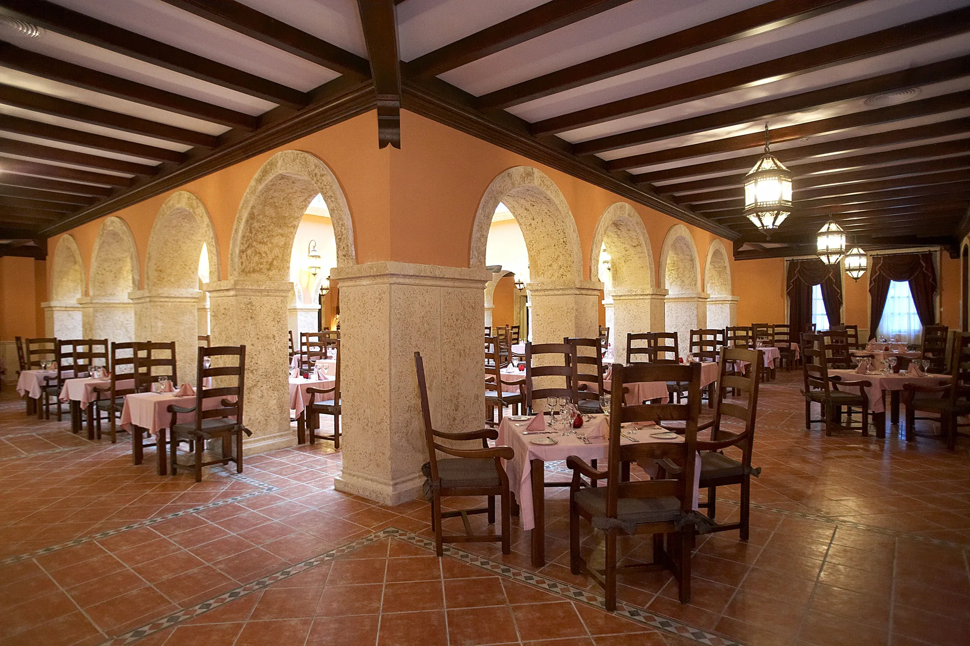 Rustic arched restaurant dining room at Majestic Elegance Punta Cana.