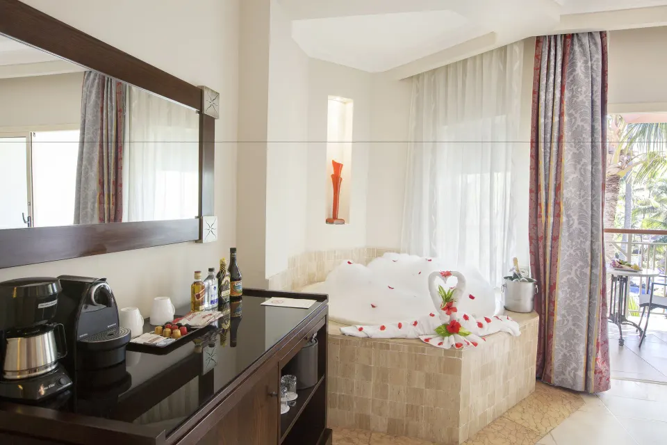 In-room Jacuzzi and beverage station at Majestic Elegance Punta Cana.