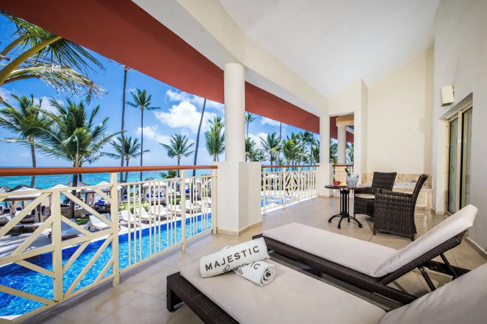 Elegance Club Ocean View Suite balcony with loungers at Majestic Elegance Punta Cana.
