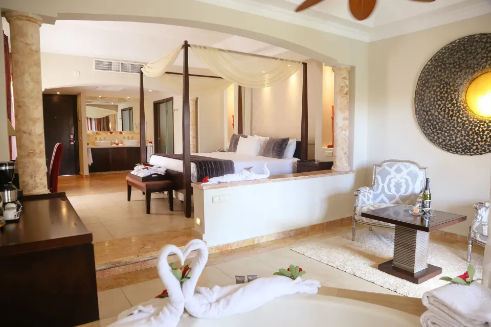 Junior Suite Jacuzzi with canopy bed beyond at Majestic Elegance Punta Cana.