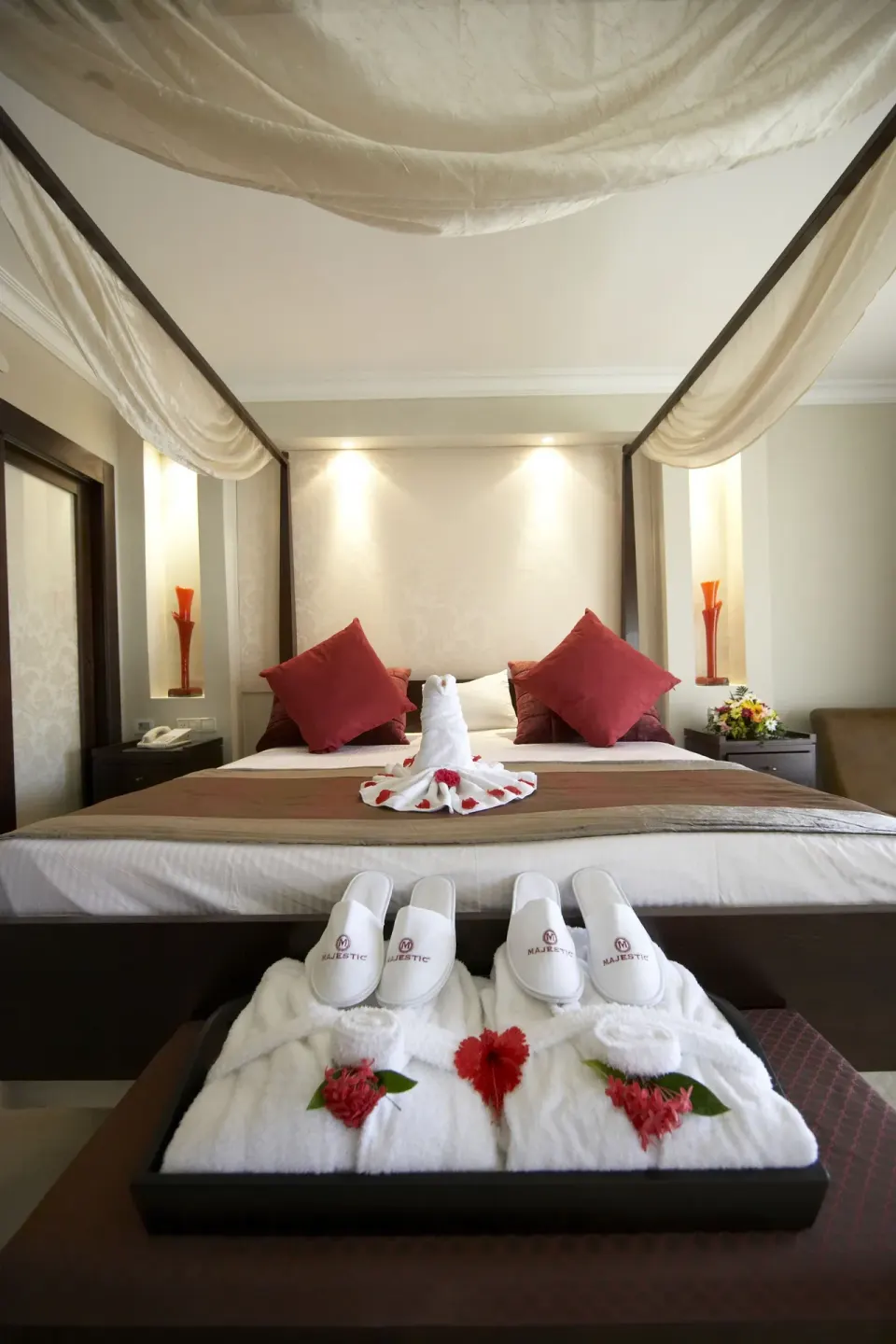 Canopy bed with towel decor in a Junior Suite at Majestic Elegance Punta Cana.