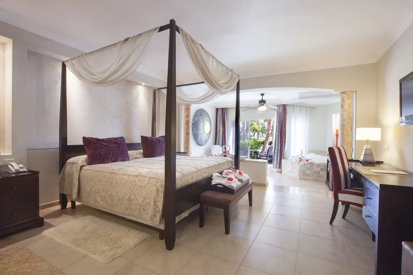 Majestic Elegance Punta Cana with canopy bed and sitting area at Majestic Elegance Punta Cana.