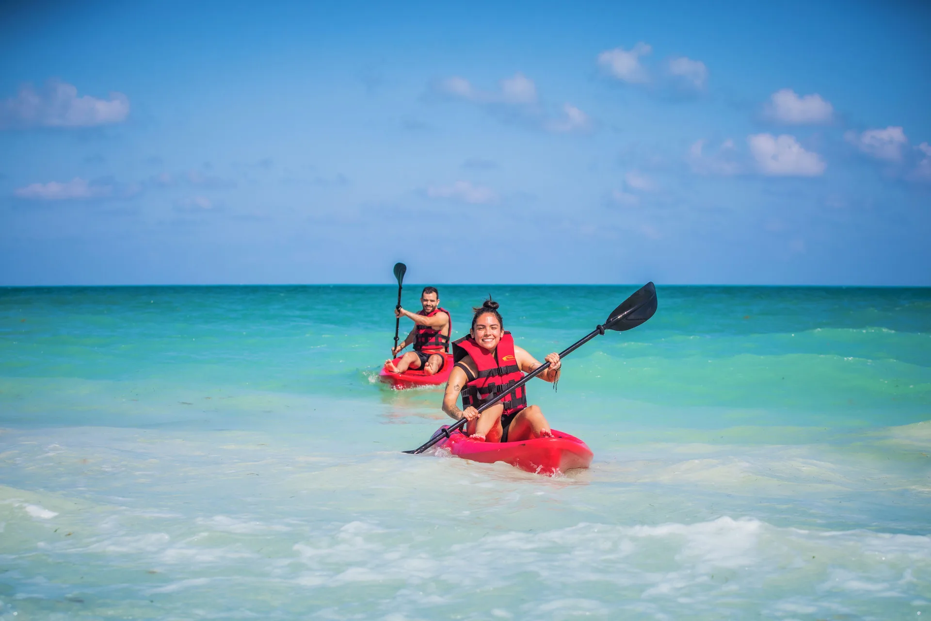 Two guests kayaking in turquoise water at Majestic Mirage Costa Mujeres.