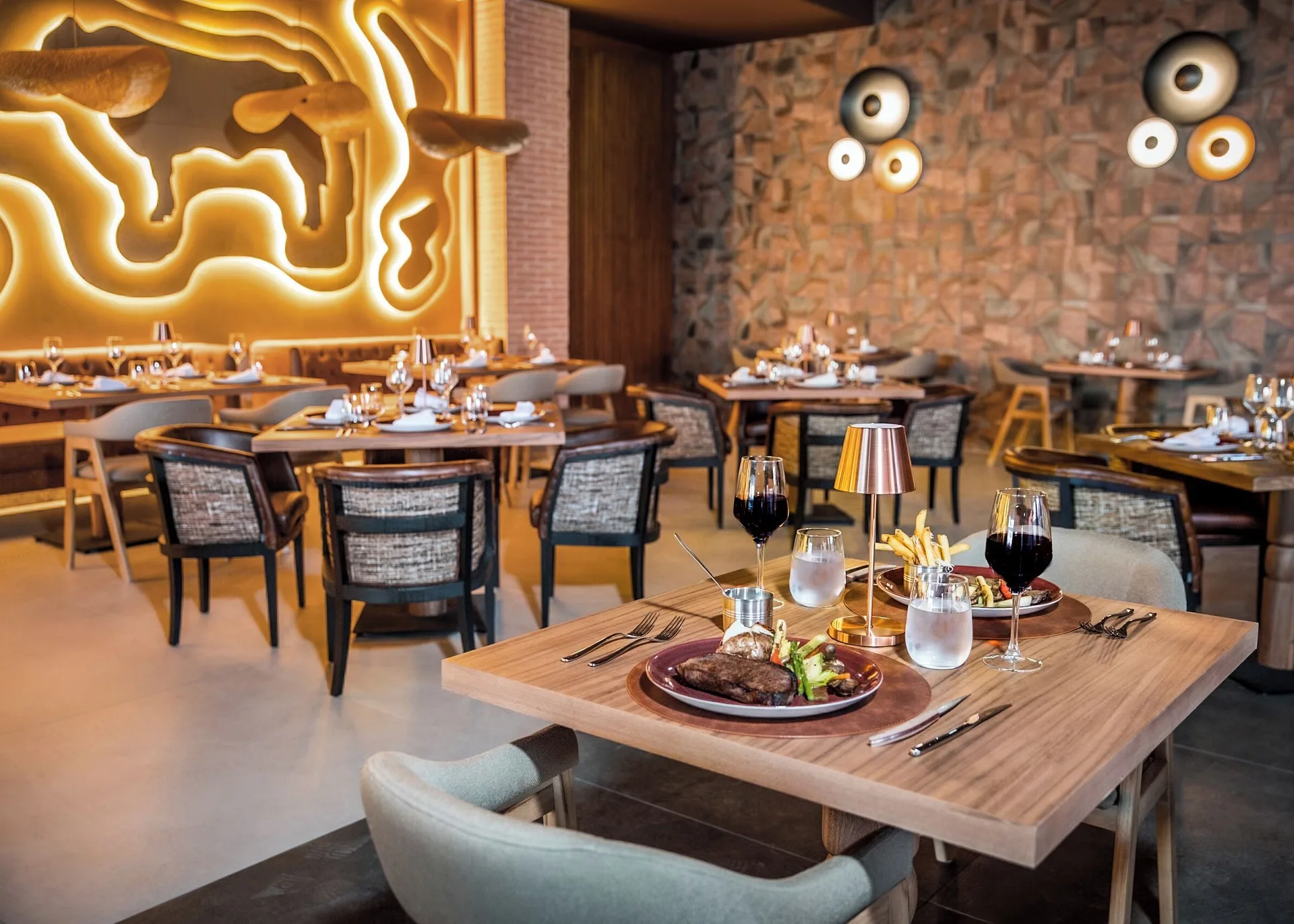 Steak dinner on a restaurant table at Majestic Mirage Costa Mujeres.