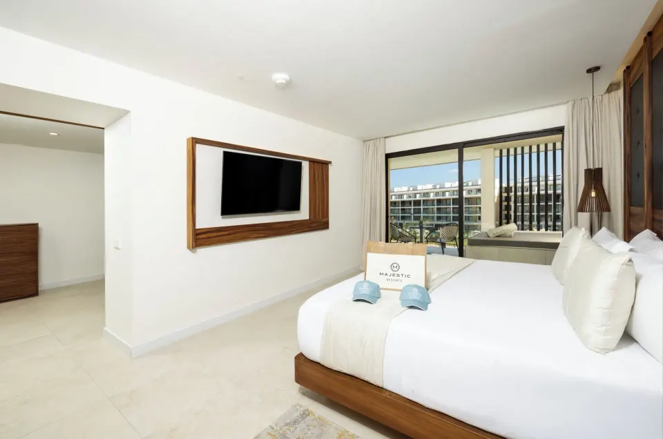 Family Club One Bedroom Suite king bed with balcony Jacuzzi at Majestic Mirage Costa Mujeres.