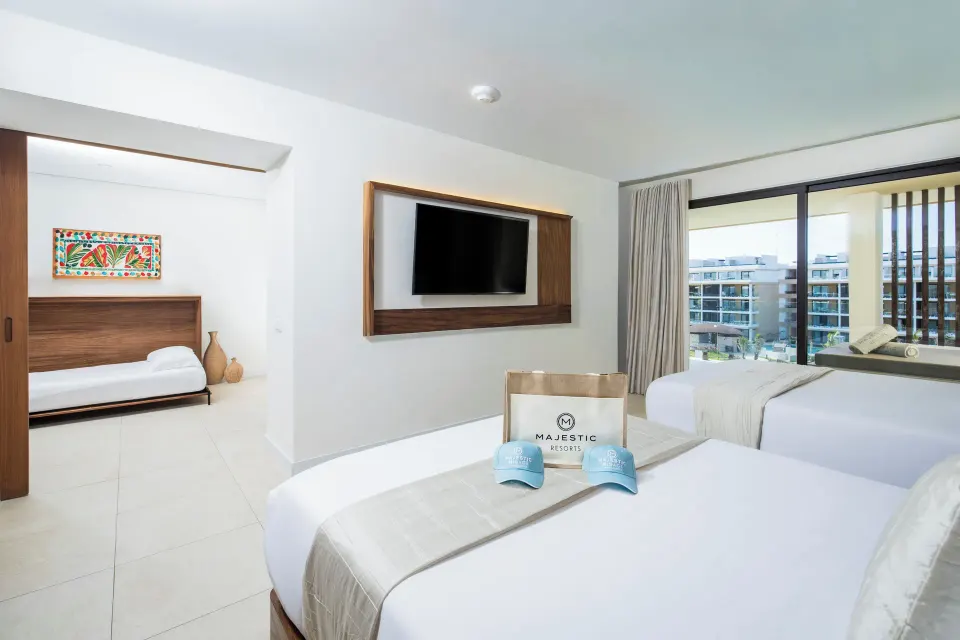 Family Club One Bedroom Suite two beds and daybed area at Majestic Mirage Costa Mujeres.