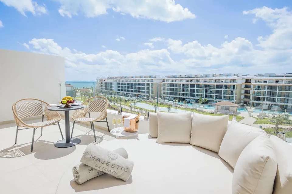 Family Club Plunge Pool Suite terrace seating at Majestic Mirage Costa Mujeres with resort and ocean views.