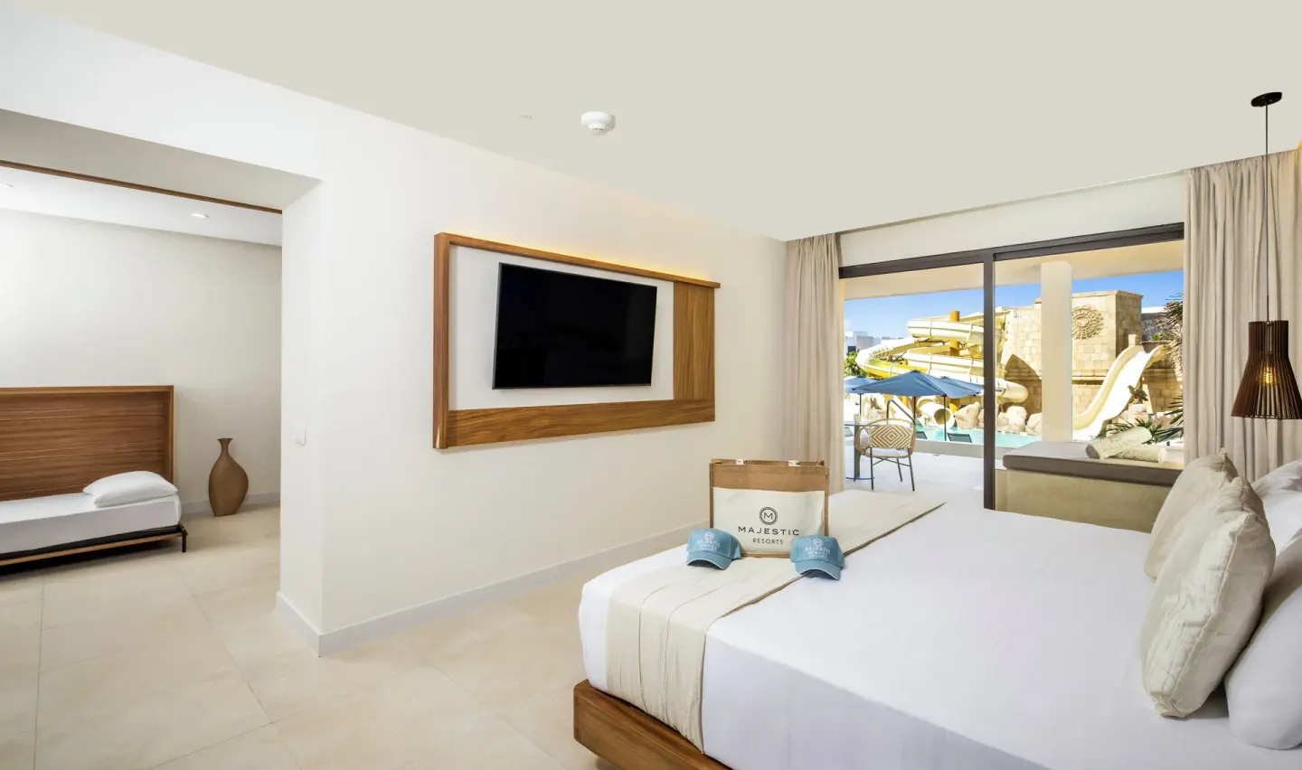 Family Club Swim-Up Suite king bed and terrace at Majestic Mirage Costa Mujeres.