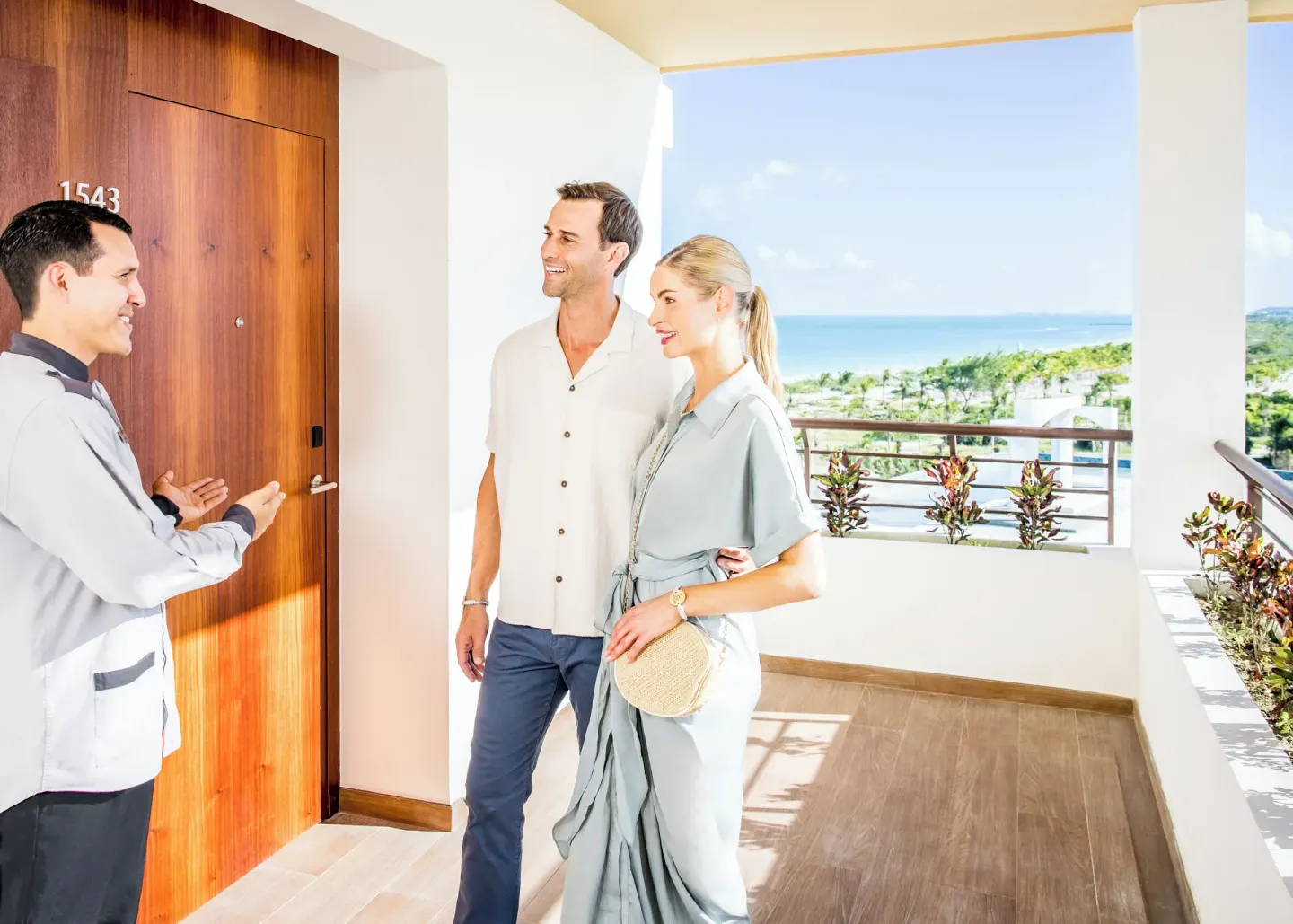 Guests arrive at a Mirage Club Oceanfront Suite doorway at Majestic Mirage Costa Mujeres.