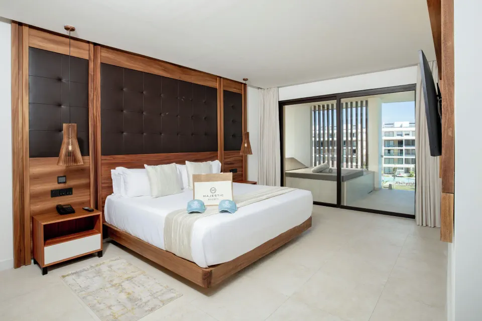 King bedroom with balcony Jacuzzi access at Majestic Mirage Costa Mujeres.
