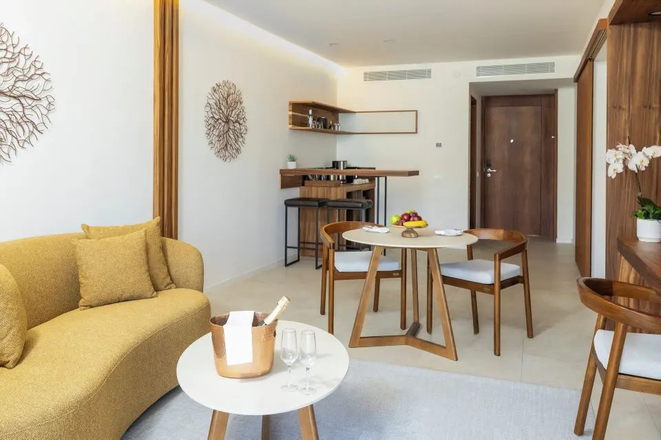 Living and dining area of a Mirage Club One Bedroom Suite at Majestic Mirage Costa Mujeres.