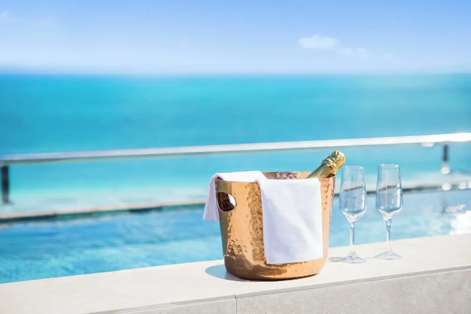 Ice bucket and glasses beside a plunge pool with ocean views at Majestic Mirage Costa Mujeres.