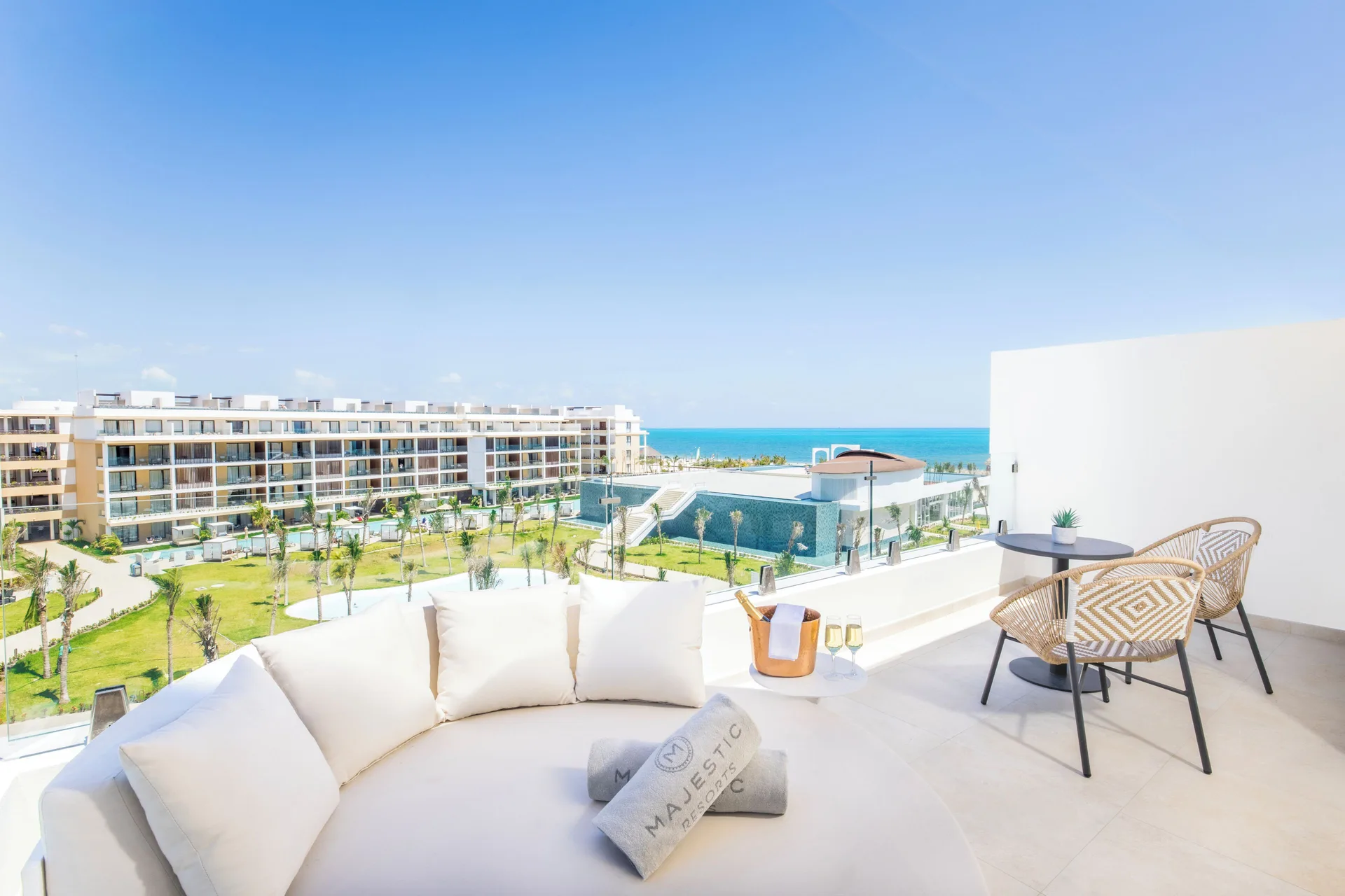 Sky-view terrace with daybed and ocean outlook at Majestic Mirage Costa Mujeres.