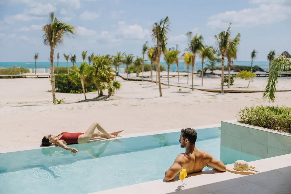 Oceanfront swim-up pool beside a suite terrace at Majestic Mirage Costa Mujeres.