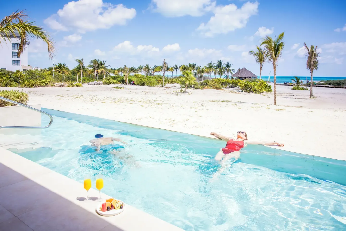 Guests in the oceanfront swim-up pool at Majestic Mirage Costa Mujeres.
