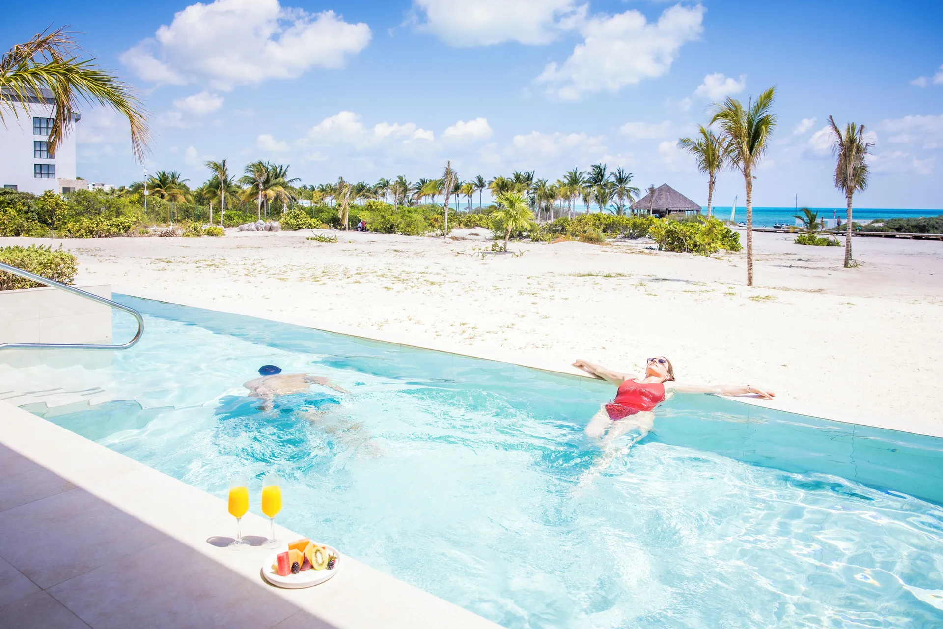 Guests in the oceanfront swim-up pool at Majestic Mirage Costa Mujeres.