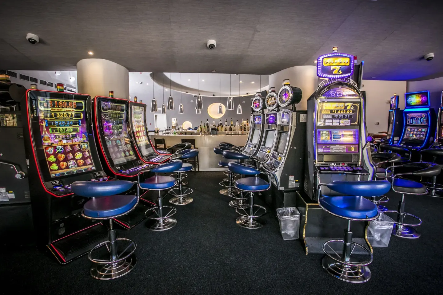 Slot machines and a bar area fill a casino room at Majestic Mirage Punta Cana.