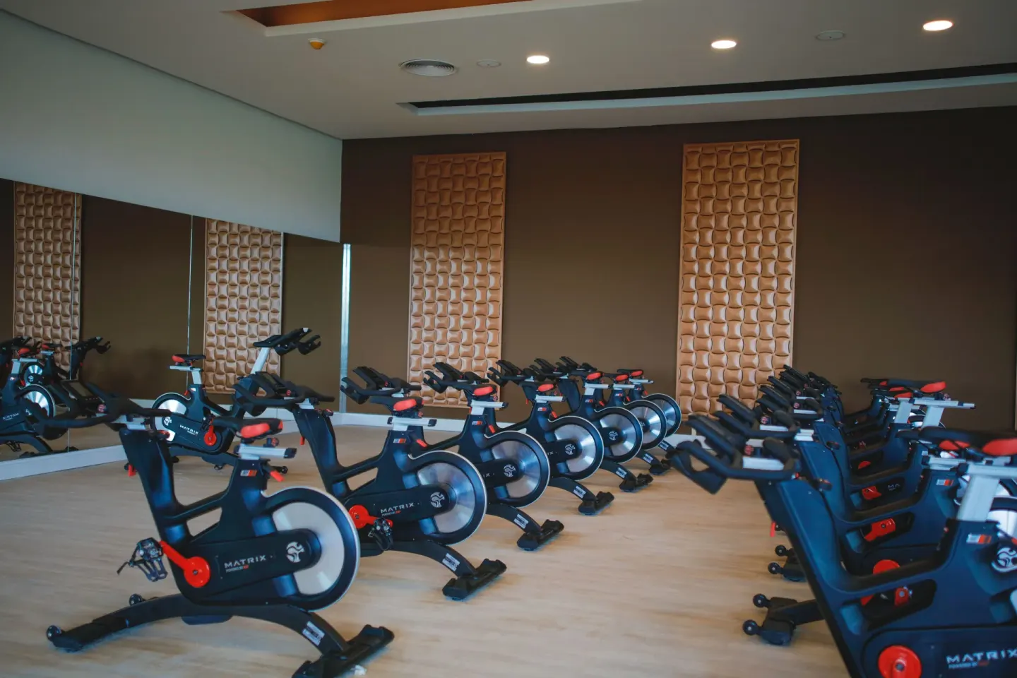 Rows of indoor cycling bikes in the fitness studio at Majestic Mirage Punta Cana.