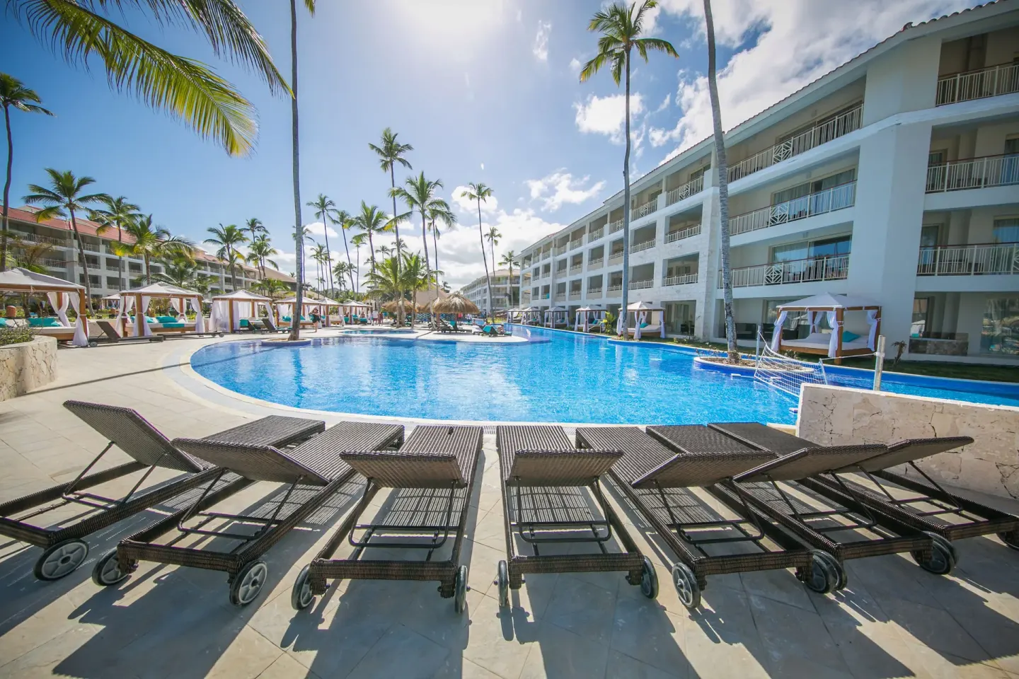 Pool deck with lounge chairs facing a large blue pool at Majestic Mirage Punta Cana.