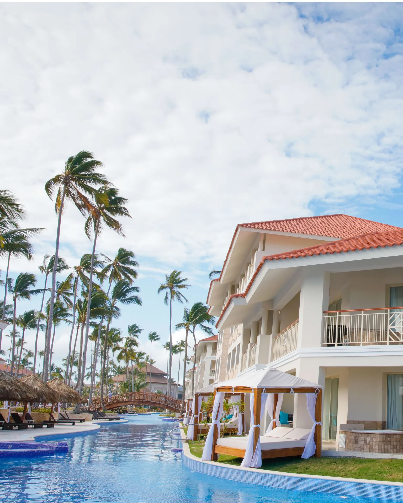 Poolside cabanas beside guest buildings at Majestic Mirage Punta Cana.