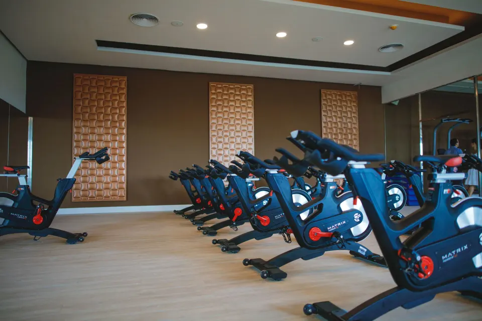 Indoor cycling studio with stationary bikes and wall panels at Majestic Mirage Punta Cana.