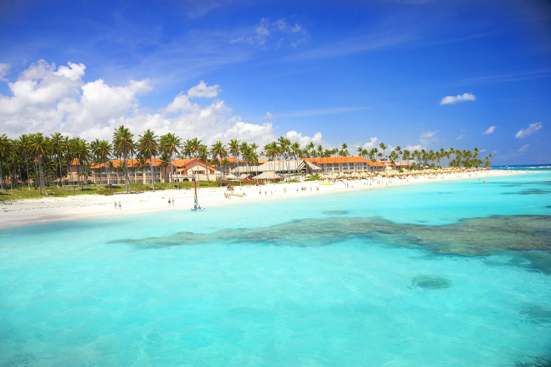 Wide beach and turquoise water along Majestic Mirage Punta Cana.