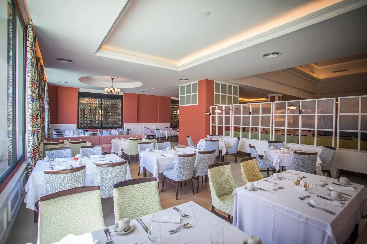 Bright restaurant dining room with white tablecloths at Majestic Mirage Punta Cana.