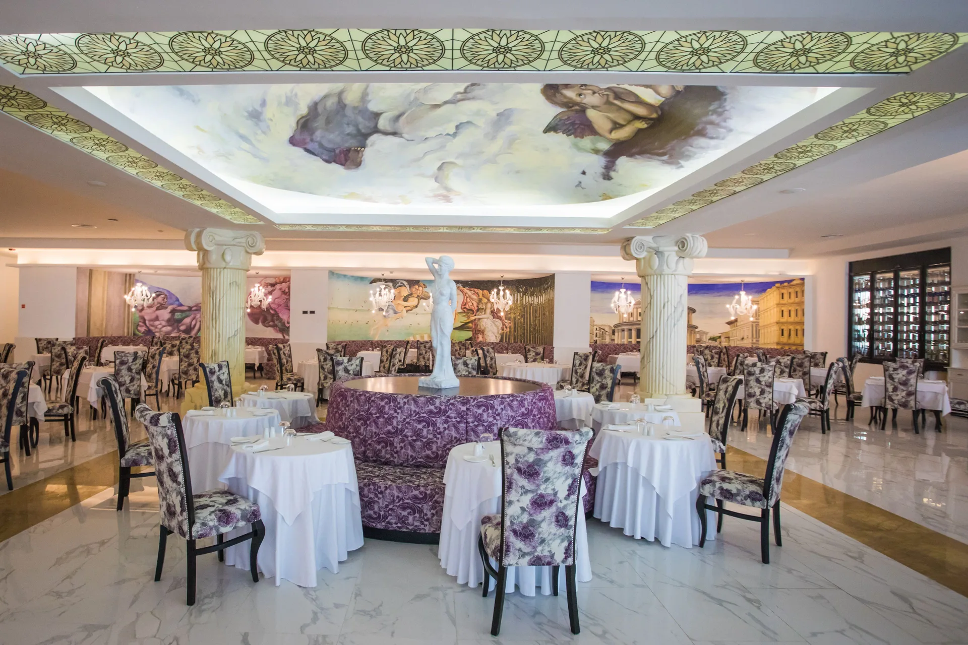 Ornate Italian-style dining room with murals and columns at Majestic Mirage Punta Cana.