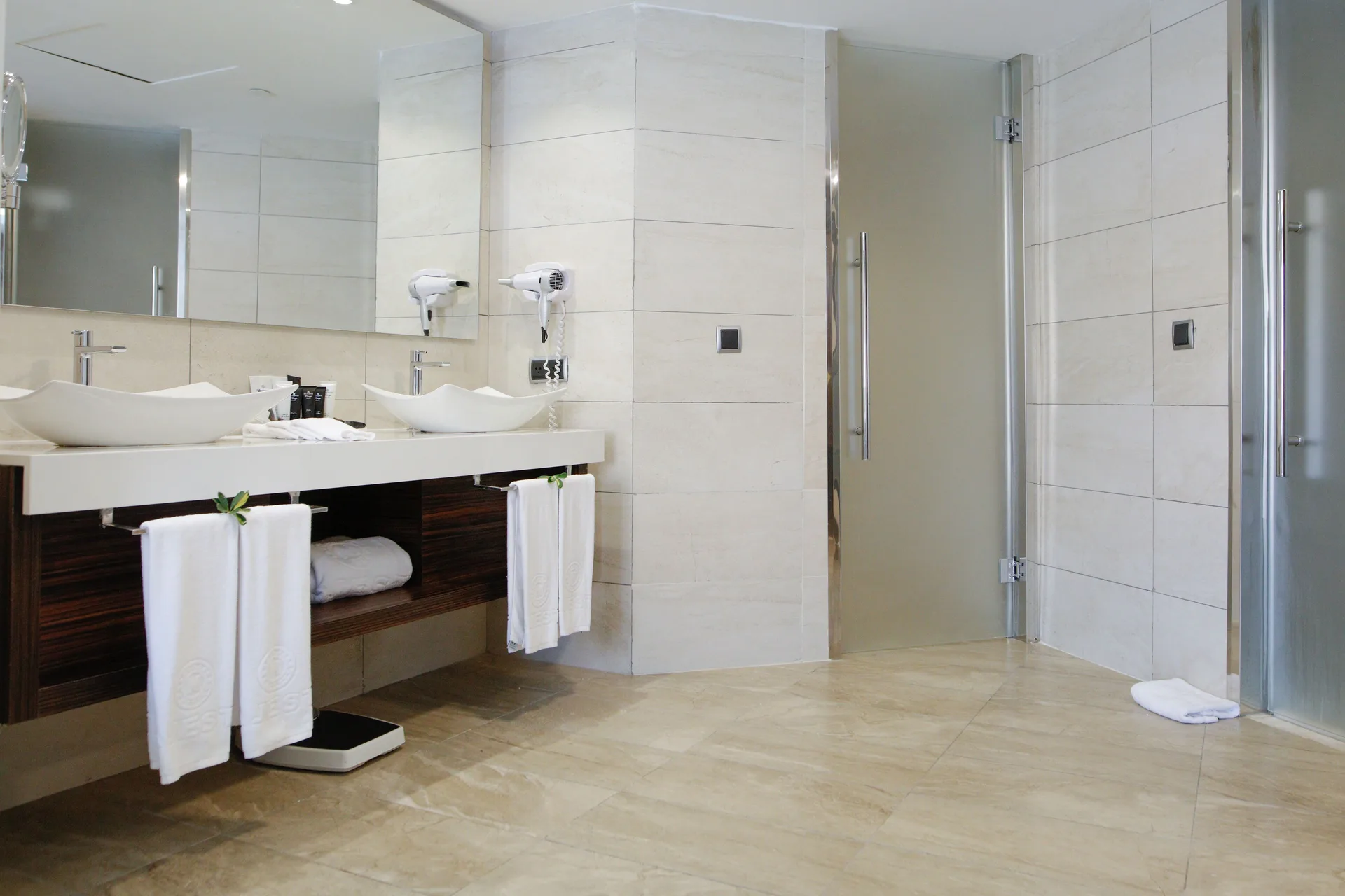 Family Suite with Outdoor Jacuzzi bathroom with double sinks and glass shower at Majestic Mirage Punta Cana.