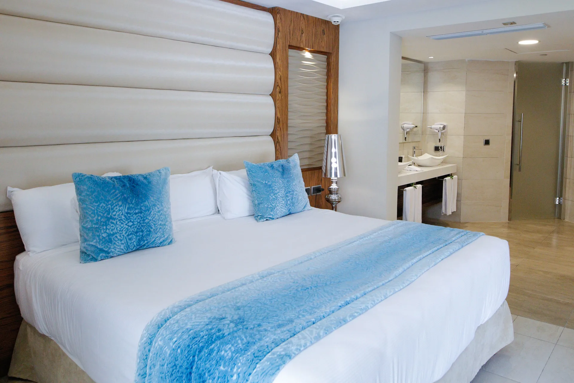 Family Suite king bed with open bathroom vanity at Majestic Mirage Punta Cana.