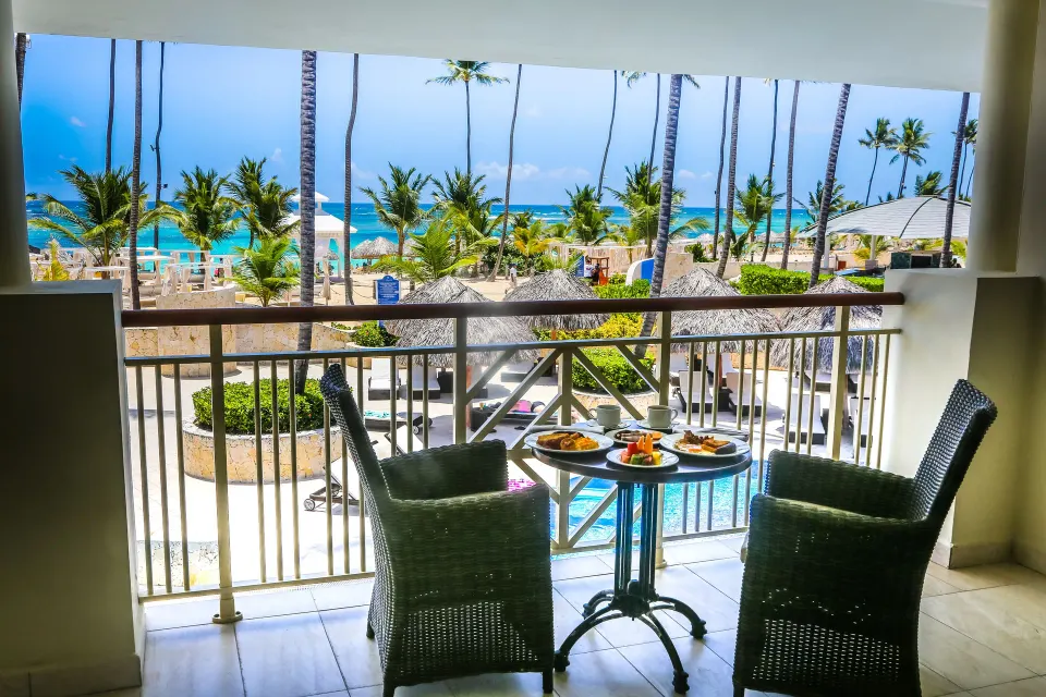 Ocean-view balcony seating in a Mirage Club suite at Majestic Mirage Punta Cana.